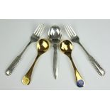 Five Georg Jensen sterling cutlery implements, comprising two gilt calendar spoons,