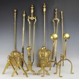 A selection of brass fire dogs and fire irons to include a three pairs of brass fire dogs,
