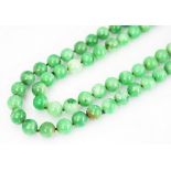 A jade coloured bead necklace,