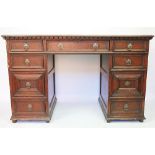 An Edwardian style oak pedestal desk, the leather inset top above an arrangement of nine drawers,