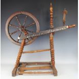 A late 18th century continental oak and beech spinning wheel,