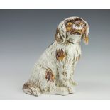 A 19th century faience model of a seated spaniel,