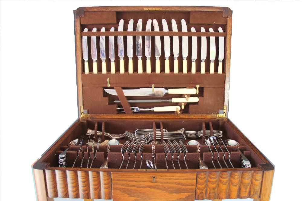 A 1930's canteen of Old English Pattern flatware and cutlery, in oak table canteen,