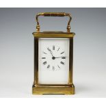 A French lacquered brass carriage time piece, with enamel Roman numeral dial,