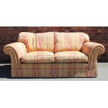 A modern two seater settee, with red and gold striped foliate upholstery,