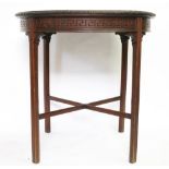 An Edwardian carved mahogany circular centre table, with a moulded edge, on square legs,