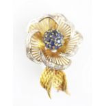 A sapphire set floral spray brooch, designed as a flower head with central sapphire set panel,
