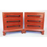 A pair of Chinese lacquered chest of drawers, with three long drawers and attached bar handles,