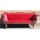 An early Victorian mahogany scroll end settee, with red drailon upholstery, on turned legs,