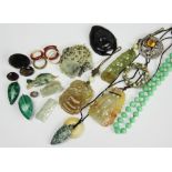 A collection of carved jade and carved hardstone pendants, to include; fish, insects,