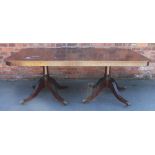 A Regency style twin pillar dining table, with turned columns and reeded legs,