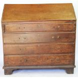 A George III oak bureau, with fall enclosing a fitted interior, above four long drawers,