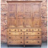 A late George III oak housekeepers cupboard, of large proportions,