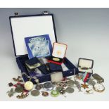 An assortment of World War II medals, all un-named, with some military buttons and cap badges,