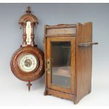 An Art Nouveau stained oak smokers cabinet, the glazed door enclosing an interior shelf, 32cm high,