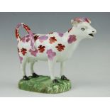 A pearl ware cow creamer, early 19th century, modelled standing,