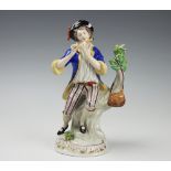 A Sitzendorf porcelain figure of The Rabbit Seller, on scroll moulded base, 23cm,