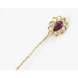 A ruby and diamond set stick pin,