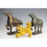 An early 20th century Chinese yellow glazed Dog of Fo, modelled playfully with pup under paw, 17.
