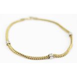 A 9ct yellow gold bracelet, of snake form and with three white metal spacers,