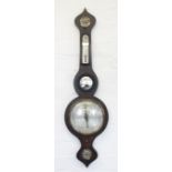 An early 19th century painted rosewood mercury wheel barometer, with four silvered dials and mirror,
