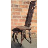 A Victorian carved oak Welsh spinners chair, the back dated 1896, on turned legs,