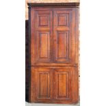 A George III oak corner cabinet with two panelled doors, above two further doors, on bracket feet,