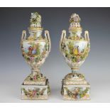 A pair of Carl Thieme Potschappel porcelain twin handled florally encrusted vases,