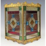 An Edwardian gilt metal and stained lead glass hall lantern, with scroll and shell detailed top,