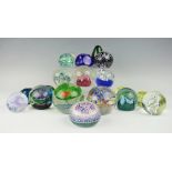 A collection of nineteen glass paper weights including four Caithness examples, a Langham example,