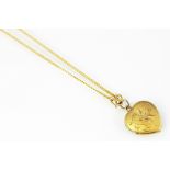 A Chinese yellow metal heart shaped locket and chain,