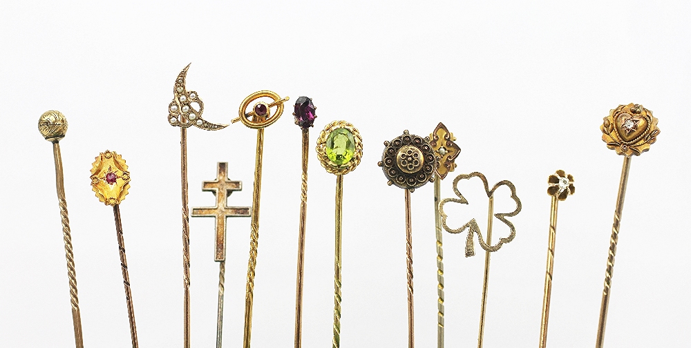 Twelve assorted stick pins, to include; garnet, pearl, peridot,