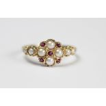 A Victorian style split seed pearl and ruby set ring in 14ct gold,