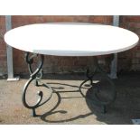 A modern conservatory / garden dining table, with polished composition circular top,