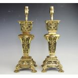 A pair of lacquered and pieced brass table lamps, each cast with masks, blossom and ducks in a nest,