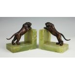 A pair of Art Deco bronzed spelter tiger bookends, each mounted on green onyx,