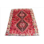 A Persian hand woven wool rug,