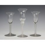 A near pair of 18th century style double opaque twist wine glasses, with flared bowls, 15cm,