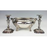 A pair of silver plated candlesticks, each florally ebossed and upon a moulded base, 18cm high,