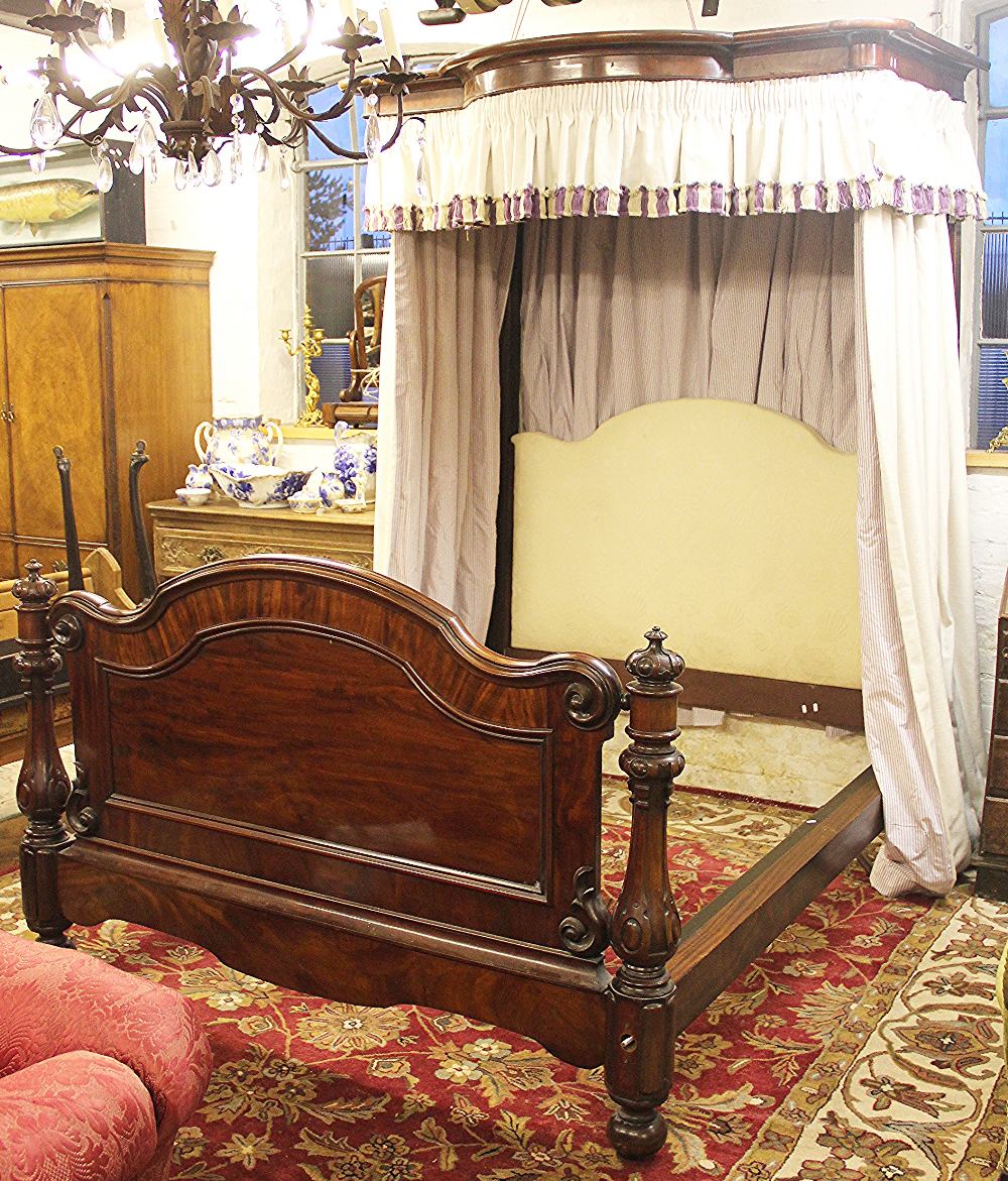 A Victorian and later mahogany half tester bed, with serpentine canopy and upholstered head board,
