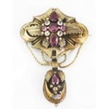A Victorian brooch, set with garnets and colourless stones,