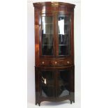 An Edwardian inlaid mahogany bow front corner display cabinet,