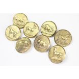 A set of eight Edwardian gilt metal hunting buttons, each embossed with a different animal,