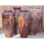 A selection of four brown and sang de boeuf drip glazed garden vases,