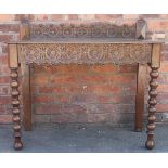 A Victorian carved oak hall table, with raised back and serpentine apron, with side drawer,