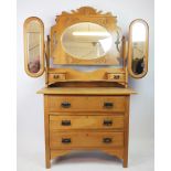 An Edwardian pine dressing chest, with mirrors and two small drawers, over three long drawers,