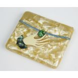 A French Art Deco cigarette case in the form of a hand bag with hand clutching the clasp,