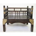 A Chinese stained pine and brass mounted opium chair, with solid seat, on moulded legs,