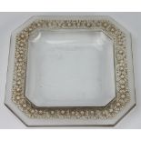 RENÉ LALIQUE, a canted square dish, cast with a a single border of stylised flower heads to the rim,