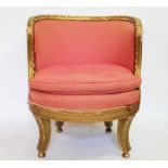 An 18th century style giltwood and gesso salon tub chair, of oval form, on sabre legs,